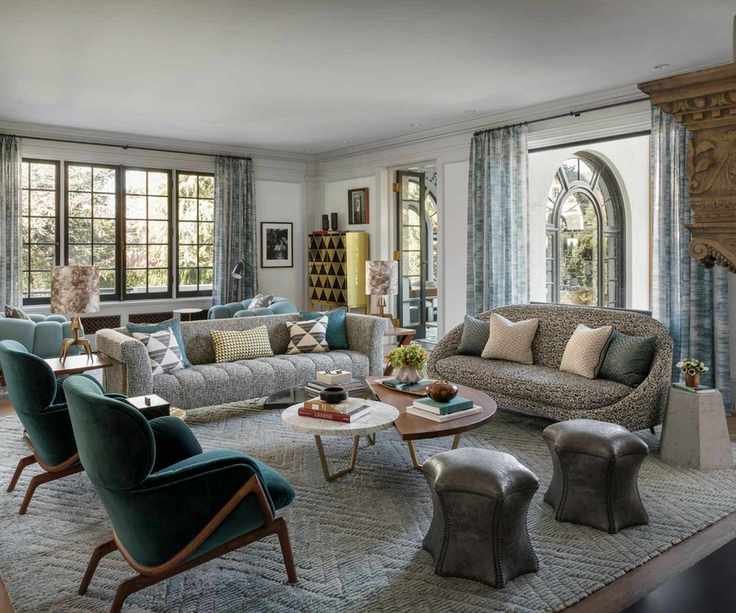 living room with two white sofas and blue chairs with windows all round