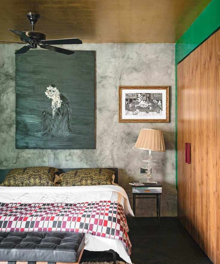 Eclectic bedroom with gold foil ceiling and large canvas above the bed
