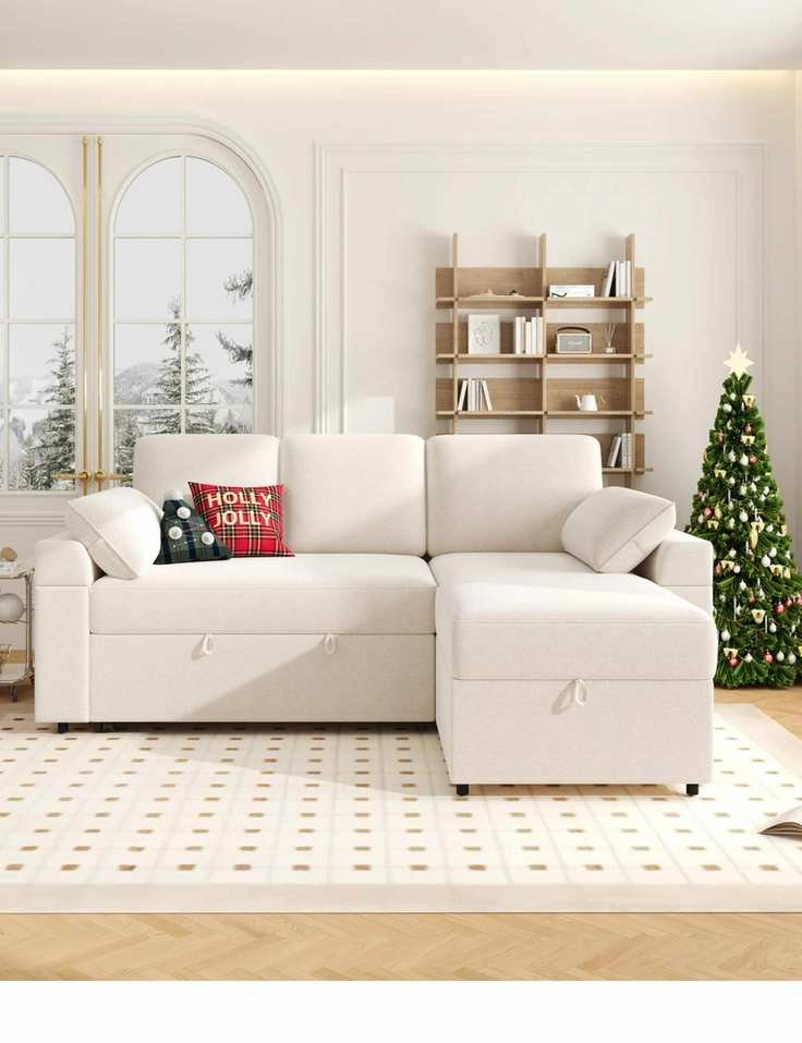 Neutral living room styled for Christmas featuring a large cushion-style sleeper sofa atop of a neutral rug geometric rug