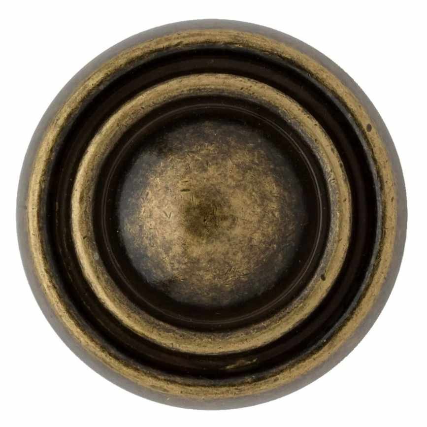 A brass circular door handle