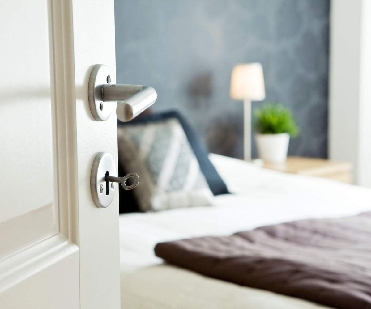 A view of a bed through an open doorway