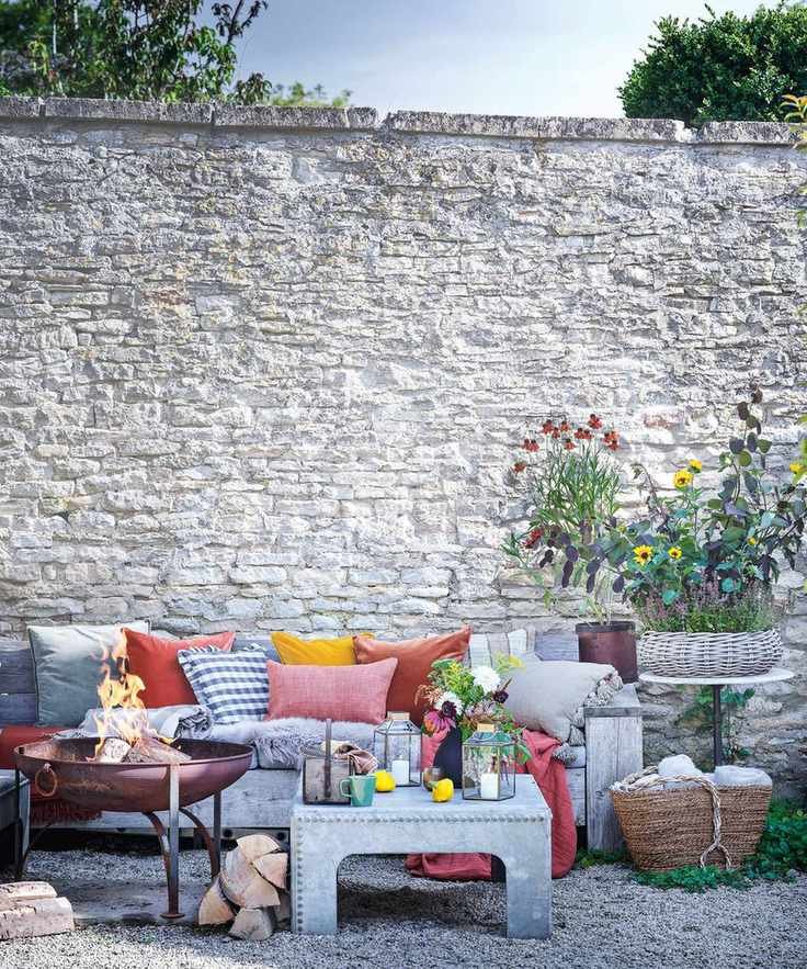 rustic seating area with red and orange cushions