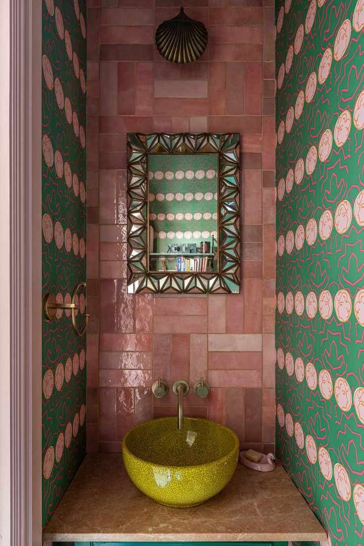 Colorful bathroom with pink tiles and green wallpaper