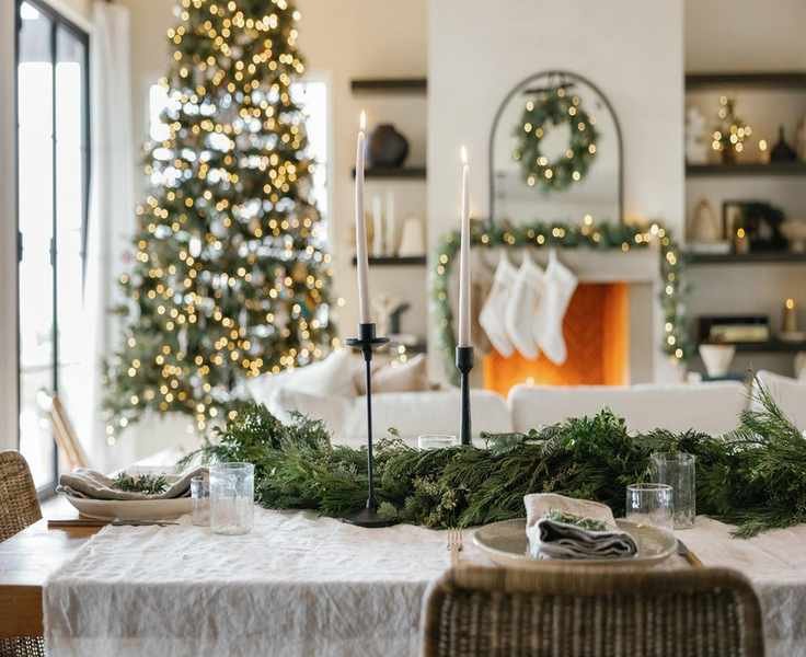 Charming Holiday Table Settings with Evergreen Accents and Twinkling Lights