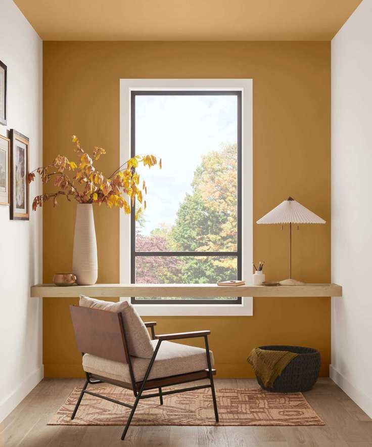 Modern home office featuring a dark yellow accent wall and two white walls