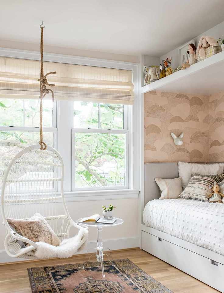 Neutral kids room with hanging swing and toy shelf