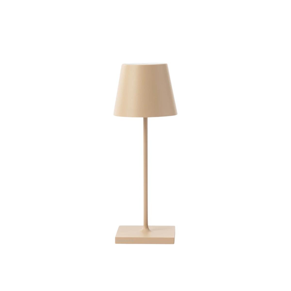 A sandy colored table lamp with a drum-shaped shade