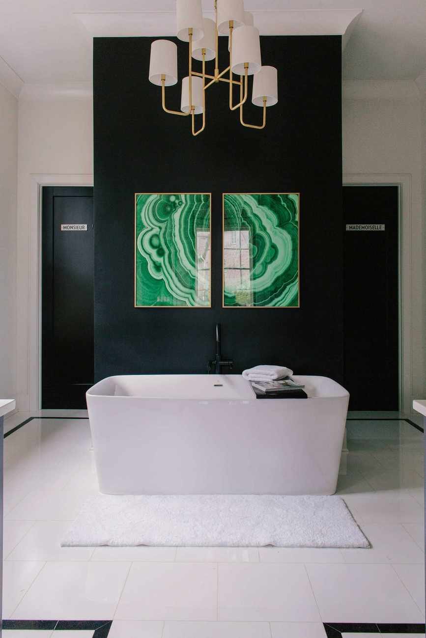 A modern bathroom with black walls and white accents